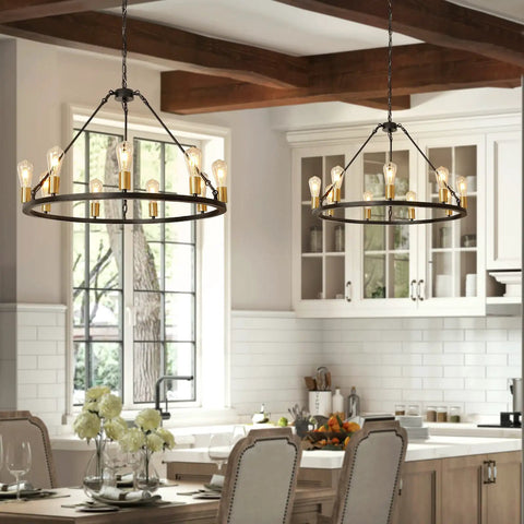 Black And Gold 9 Light Industrial Wagon Wheel Farmhouse Chandelier hanging in modern kitchen with white cabinets