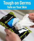 Hands holding On The Go Tech Wipes Pack Of 3, 25 Count Each, Travel Size Skin Safe Clean For Screens Phones Keyboards Monitors TVs And More.