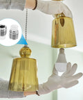 Person installing Built Tough M12 Nylon Tip Grub Screws Five Pack Heavy Duty Hex Socket Cap Set Screws in light fixture.