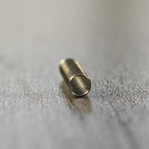 Close-up of stainless steel keyboard switch spring for Cherry MX and Gateron MX (150g)