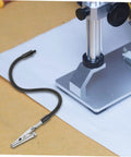 Close-up of a clamp with flexible arm next to a base from the Six Piece Flexible Third Hand Soldering Tool Set With Adjustable Arms PCB Holder And Magnifying Lamp For Precise Electronics Welding And Crafts Dope For DIY Projects Soldering Stations PCB Assembly And Detailed Electronics Work