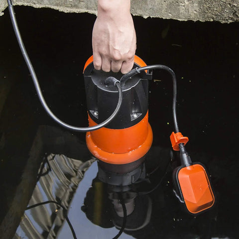 Person holding 1HP Submersible Sump Pump With Automatic Float Switch, 3700GPH Clean Or Dirty Water Pump for flooded cellar, orange.