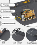 Extra Large Soldering Mat With Wrist Strap And Grounding Accessories, 23.6 x 13.8 Inches, shown with tools and pcb on gray surface