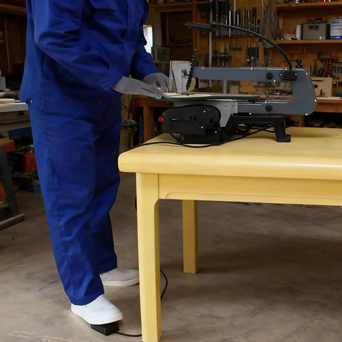 User operating Heavy Duty 10 Foot Momentary Foot Switch Pedal Controller with a power tool at a workshop.