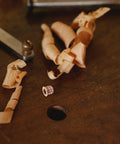 M6x10mm Countersunk Flange Wood Nut Inserts For Cabinets And Desks with wood shavings on a workbench