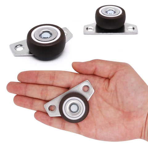 Hand holding a 1.25-inch caster from 8 Pack One And One Quarter Inch Low Profile Fixed Side Mount Casters Wheels For Furniture Underbed Cabinets Non Swivel Drawer Rollers Rigid Small Wheels Space Saving Design Load 36 Lb Each Easy Glide Replacement