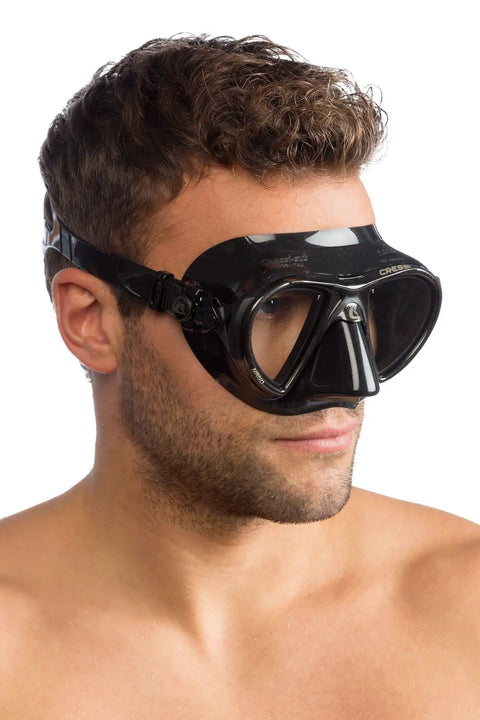 Man wearing Nano 2-Lens Dive Mask For Scuba And Freediving, ultra low-profile hydrodynamic design, black on black silicone build.