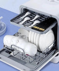 Ultra Compact Countertop Dishwasher Total Game Changer For Small Kitchens Fully Automatic Four Cycle Wash System Featuring Fast Auto Dry Plus Straight Up Slick Faucet Hookup Or Simple Manual Fill Setup with plates, bowls, and cutlery inside.