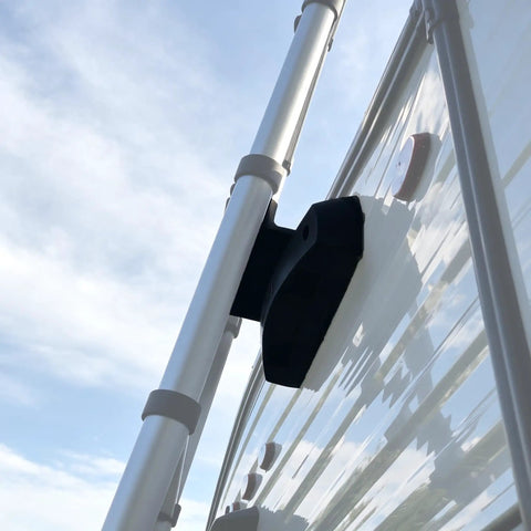 Rugged RV Ladder Bracket With Snap Fit Mount For On-The-Go Ladder System attached to exterior of camper