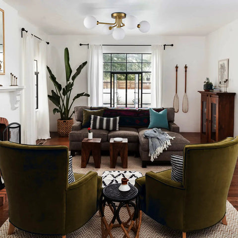 Gold Sputnik Ceiling Light Fixture With Globe Shades in modern living room with green chairs and large window