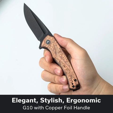 Kickass EDC Folding Knife With Beefy Liner Lock And Sick Copper Drip G10 Handle Featuring Razor Sharp 14C28N Steel Blade held in hand.