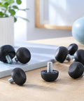 Rock Solid Adjustable Furniture Levelers Built From Tough 304 Stainless Steel And Heavy Duty Screw In Table Feet for wobbly chairs or desks on a wooden surface.