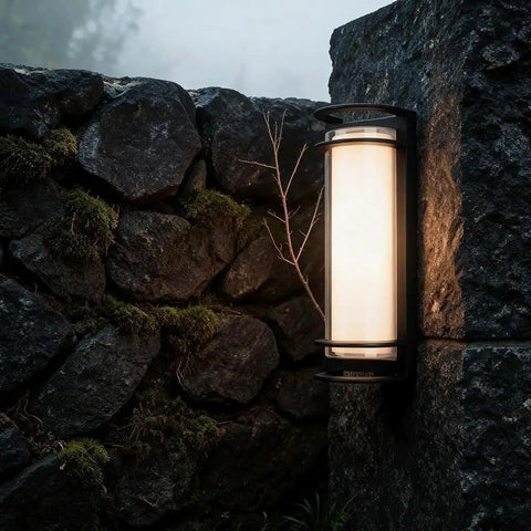ROPCVAX Led Wall Sconce Lighting Fixture Lamp Modern Minimalist Aluminum Black mounted on stone wall, providing soft illumination.