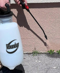 Person using 2 Gallon Lawn And Garden Sprayer For Controlling Insects And Weeds Or Cleaning Decks And Siding With Comfort Grip