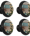 Four matte black daisy cabinet knobs with crystal glass front, showcasing wood and flower design, for kitchen and bathroom cabinet hardware.