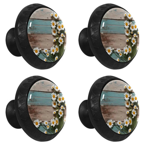 Four matte black daisy cabinet knobs with crystal glass front, showcasing wood and flower design, for kitchen and bathroom cabinet hardware.