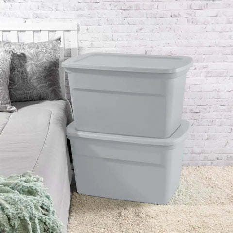 Six Pack Heavy Duty 30 Gallon Plastic Storage Containers With Secure Lids Hella Roomy Gray Bins stacked beside bed in bedroom.