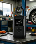 Slick Wireless Rechargeable Car Air Compressor Fast Tire Inflator With Easy Digital Display Auto Shutoff Portable Pump on workshop table.