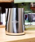 32 Oz Milk Frother Pitcher With Clear Scale, 304 Stainless Steel Steaming Jug And Latte Art Pen on kitchen counter