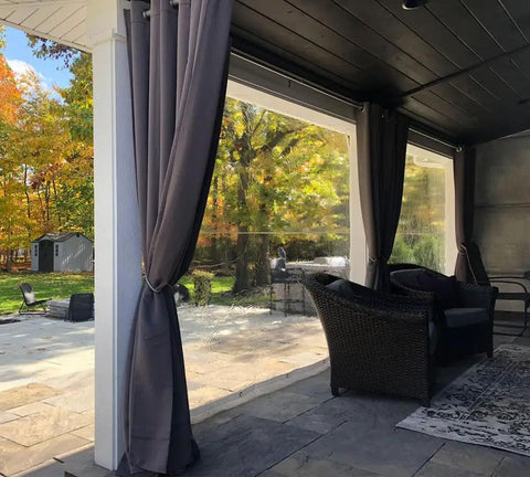 Outdoor patio with Beefy 10x12 Clear Vinyl Tarp 24 Mil Thick Heavy Duty Waterproof Cover, grommets visible, garden view.