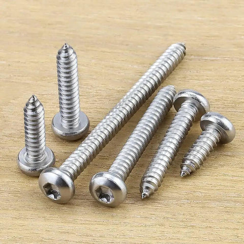 Number 12 By Three Quarter Inch Pan Head Torx Self Tapping Screws Made From 304 Stainless Steel on wooden surface
