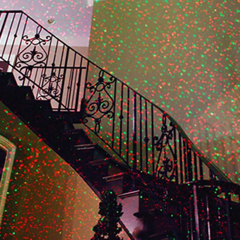 Motion Laser Holiday Projector with thousands of lights creating red and green patterns on staircase railing indoors