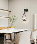 Dining room with Industrial Vintage Matte Black Globe Wall Sconce Set of 2 With Clear Hand Blown Glass Shades on wall