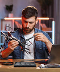Man repairing drone with Dope Micro Screwdriver Set 50 In 1 Precision Kit With S2 Steel Bits at a desk
