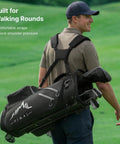 Man carrying black 14 Way Golf Stand Bag For Men And Women With Stand Feature Lightweight And Durable Golf Club Bag 14 Divider System