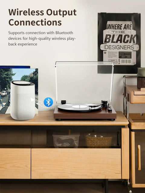 Bluetooth Turntable Player With Built In Phono Preamp And Magnetic Cartridge Belt Drive Records Player 2 Speed Vinyl Record Deck on a table with a wireless speaker.