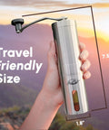 Manual Stainless Steel Coffee Grinder With 18 Adjustable Settings shown in hand, highlighting its travel-friendly size, 7.5 inches tall.