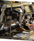 Commercial coffee machine with steam wand rubber sleeve in use, emphasizing accessories kit and pipe insulation.