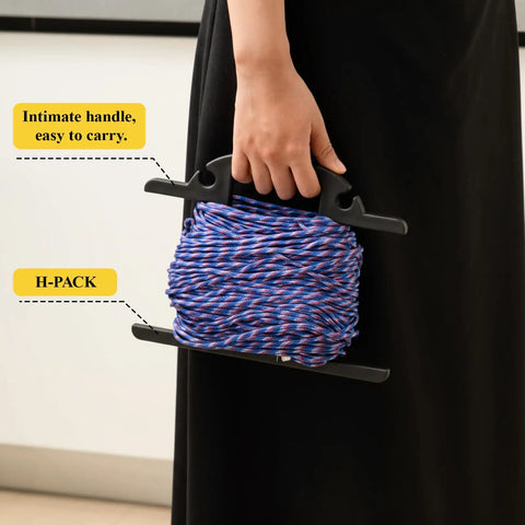 Person holding Heavy Duty Extension Cord And Hose Reel With Carrying Handle For Easy Yard Setup, H-shape organizer, black