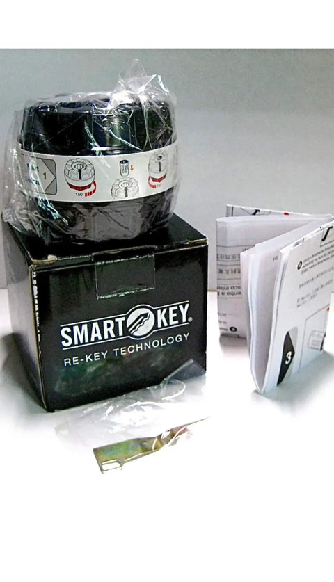 SmartKey Reset Cradle For Kwikset Lock Cylinders Easy To Use Replacement Tool next to instruction manual on white background