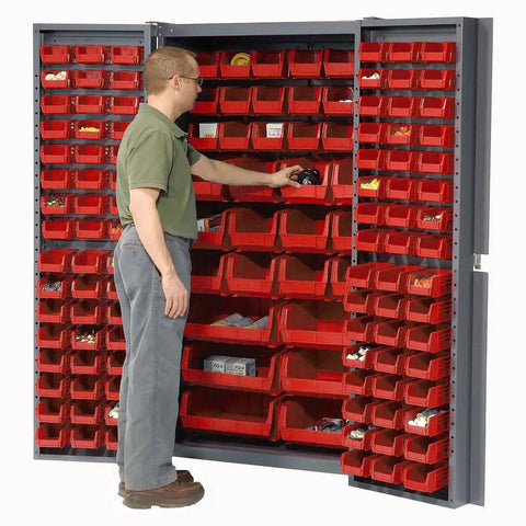 Man organizing items in Straight Up Heavy Duty Storage Bin Cabinet With 132 Red Plastic Organizers Featuring Slick Louvered Doors Swinging Wide Open For Quick Workshop And Garage Setup.