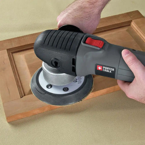 Person using Powerful 4.5 Amp 6 Inch Orbital Sander And Polisher With Variable Speed 2,500 To 6,800 OPM on wooden surface
