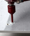 ONEGOTOOL diamond hole saw drill bit, 1/4in (6mm), red, front view drilling into ceramic tile