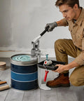 Man using Heavy Duty Manual Loading Pump For Thick Paste And Liquid Transfer With Long Handle for paint transfer from a drum.