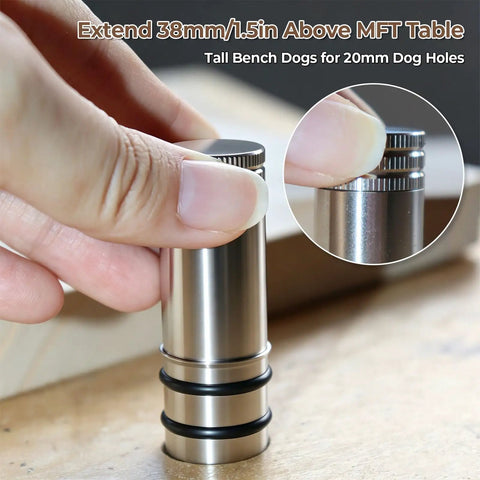 Person holding Two Pack 20mm Bench Dog Set for MFT workbenches aluminum positioning stop posts on a wooden surface