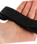Hand holding black nylon strap, part of 8 Pack Garden Aerator Shoes Straps For Lawn Care Durable Spiked Sandals For Grass Aeration Easy To Use Lawn Aerating Shoe Straps For Men And Women Everyday