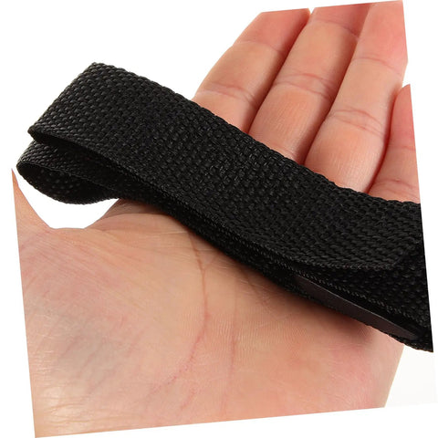 Hand holding black nylon strap, part of 8 Pack Garden Aerator Shoes Straps For Lawn Care Durable Spiked Sandals For Grass Aeration Easy To Use Lawn Aerating Shoe Straps For Men And Women Everyday