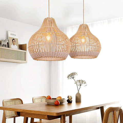 Two rattan round pendant lights above a kitchen island, showcasing the coastal wicker chandelier design, handmade with a warm glow.