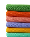Stack of colorful mesh fabrics, featuring green, orange, pink, purple, yellow, and mint, for air beds upholstery and crafts.