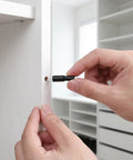 Inserting Locking Shelf Pins With Rubber Covers Carbon Steel Black 24 Piece Set into cabinet hole