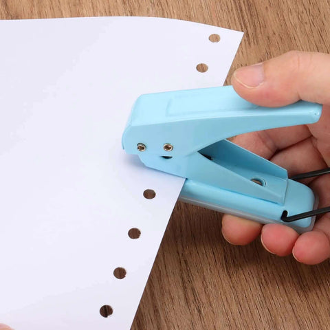 Hand using One Quarter Inch Hole Punch Handheld Heavy Duty Metal Paper Punch for tags, DIY projects, scrapbook, tickets, ergonomic blue grip