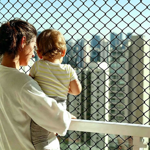 Kid and Pup Safe Rope Net for Balcony Railings with adult and child, city view, knotless polyester safety netting visible