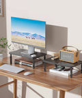 Go To Adjustable Desk Monitor Stand With Laptop Riser And Under Desk Storage, Black metal frame, non-slip rubber pads on wood desk.