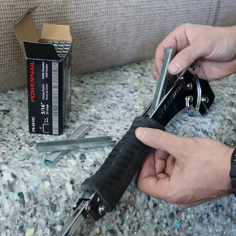 Person loading staples into Heavy Duty Hammer Tacker Stapler for 20 Gauge 1/2 Inch Crown with Quick Jam Release, Bottom Loading