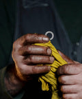 Set Of Twenty M10 Wedge Locking Washers Built Tough With Premium Manganese Steel for automotive use, held in hands with a cloth.