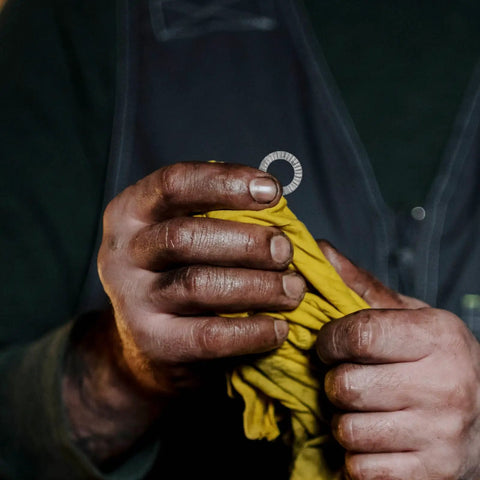 Set Of Twenty M10 Wedge Locking Washers Built Tough With Premium Manganese Steel for automotive use, held in hands with a cloth.